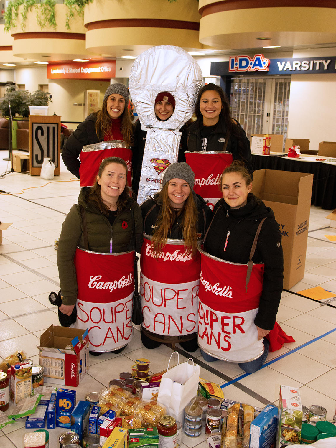Alumni dressed as soup cans at Trick or Eat