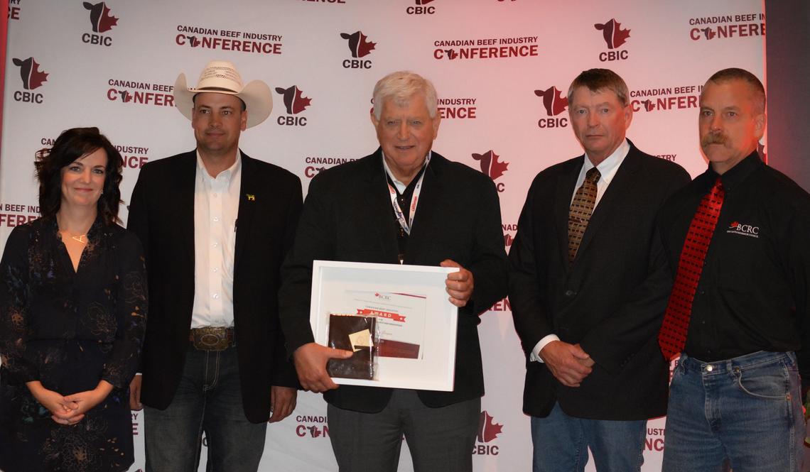 The University of Calgary's Eugene Janzen is awarded the 2018 Canadian Beef Industry Award for Outstanding Research and Innovation. From left: Andrea Brocklebank, BCRC executive director; Ryan Beierbach, BCRC chair; Eugene Janzen; Bob Lowe, Bear Trap Feeders; and Reynold Bergen, BCRC science director.