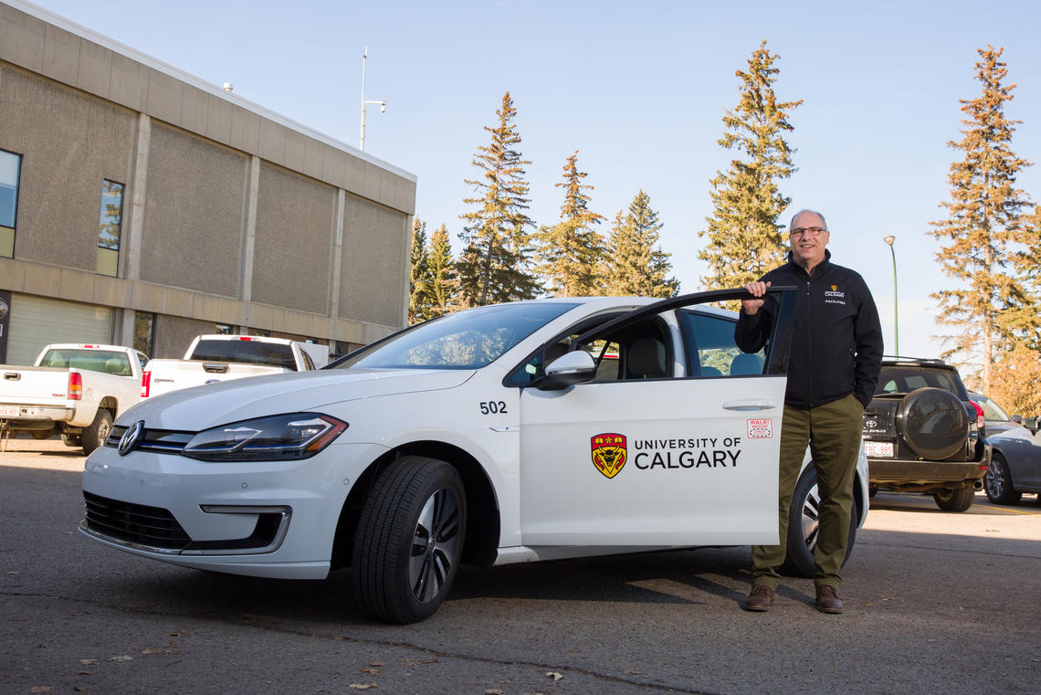 Facilities’ Lee Ferrari, senior manager, fleet and municipal services, with one of the four new electric vehicles helping to make campus operations more sustainable.