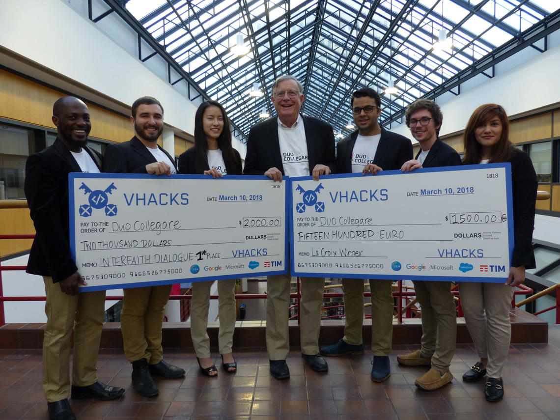The UCalgary Vatican Hacks team members pose proudly in Scurfield Hall with their competition winnings. From left: Frances Duahn, Eric Eidelberg, Sharon Wang, Bob Schulz, Raza Qazi, Sasha Ivanov, and Megha Chopra.