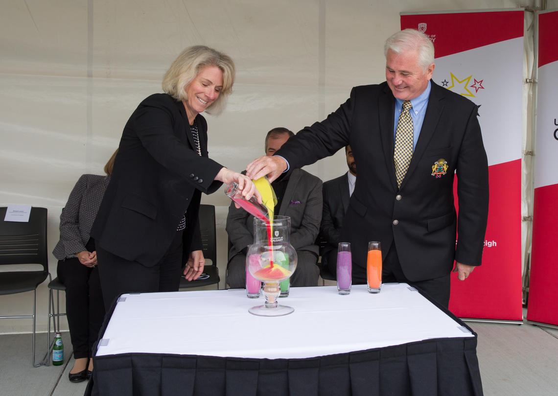 President Elizabeth Cannon and Deputy Mayor Ward Sutherland participate in the sand ceremony commemorating the opening of the student residences. 