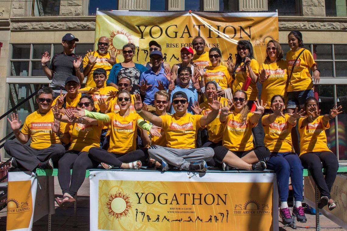 University of Calgary co-op student Amy Stratulate, third from the left in the front row, celebrates after she helped organize one of Canada’s largest outdoor yoga charity events. 