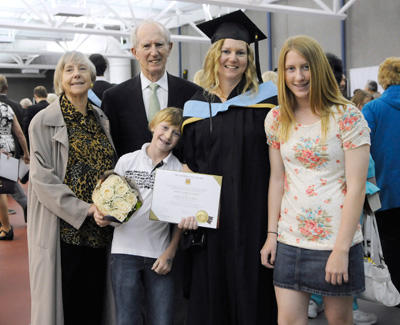 Margo Dilger celebrates another degree for the family along with mom Ute, dad Walter, and kids Dominic and Mia Soucie.