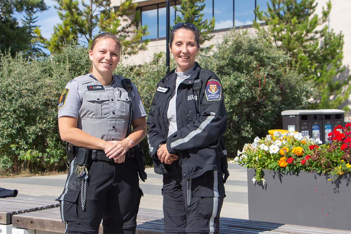 Campus security officers smile at camera
