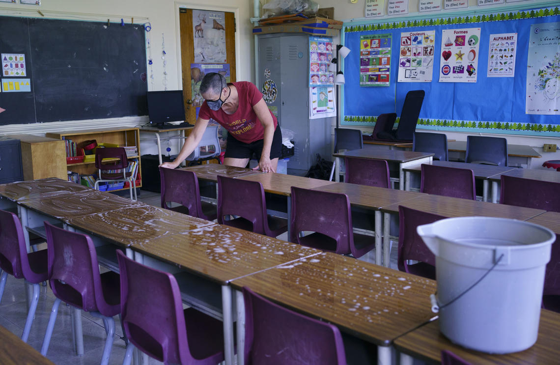 Grade two teacher Nancy Poirier washes the desks in her classroom at the Willingdon Elementary School in Montréal in August 2020. 