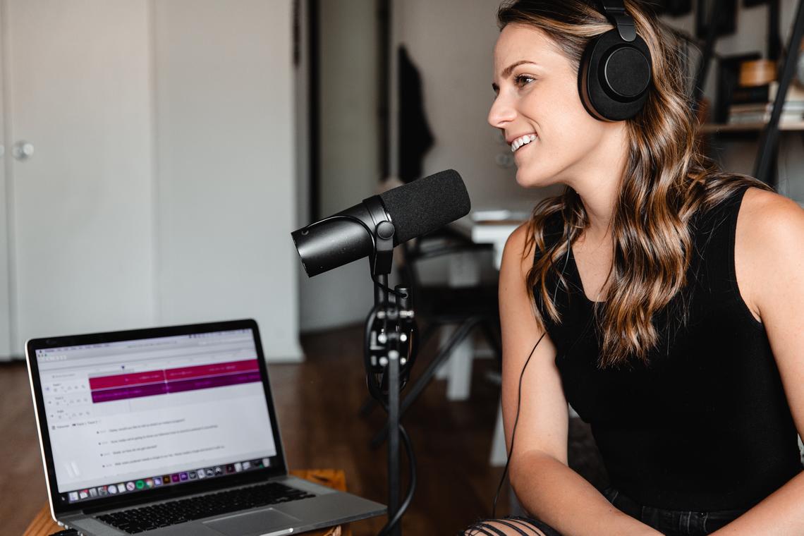 woman speaking into podcast microphone
