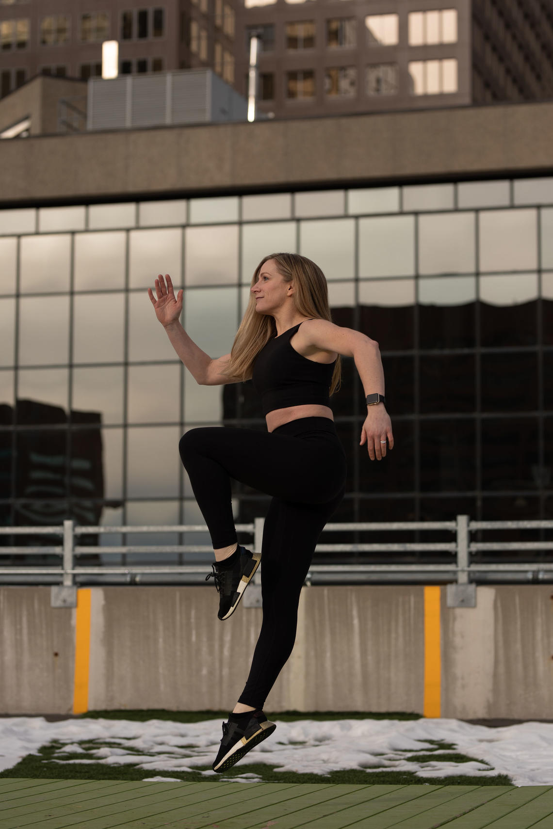 Jenn Varzari performs a single-leg hop on a rooftop in downtown Calgary