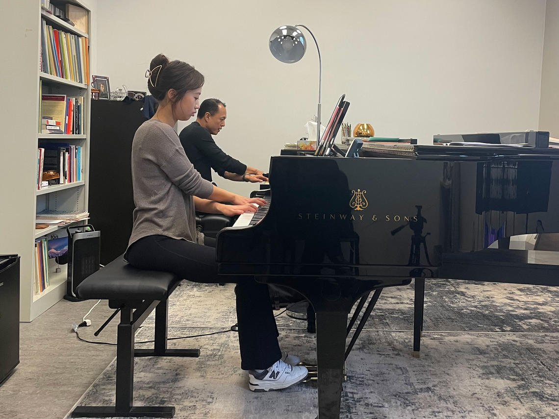 Piano student Renee Pi practices with composer Vincent Ho