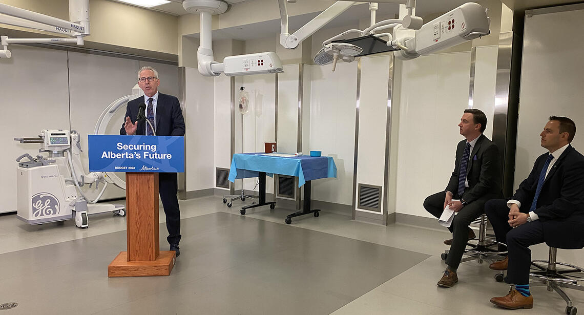 UCalgary President and Vice Chancellor Dr. Ed McCauley, PhD, speaks at a Foothills Campus press conference, while Jason Copping, Minister of Health (L) and Demetrios Nicolaides, Minister of Advanced Education look on
