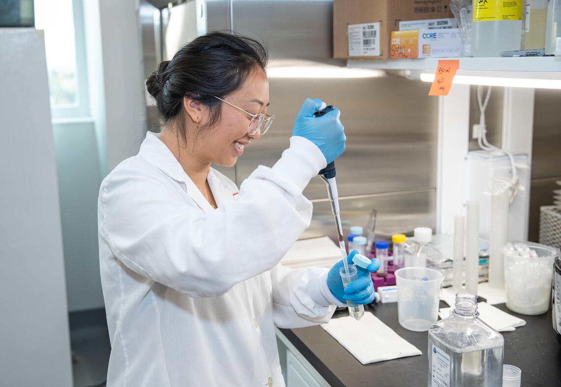 a PhD student does research in a cancer lab