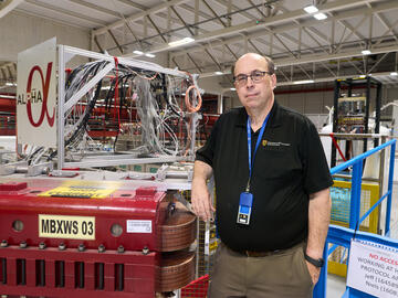 UCalgary physics professor Robert Thompson in front of ALPHA experiment at CERN. 