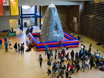 Students line up to ascent an inflatable mountain