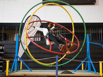 A student has fun on a gyroscope ride