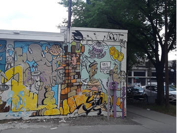 A colourful mural on the side of a building with the words "Yay Kerby."