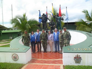 Monica Franco in U.N. uniform stands with members of the Colombian military 