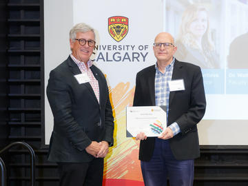 Dr. David Nicholas (Faculty of Social Work), right, receives a Killam Annual Professor Award from Killam Trustee Jim Dinning