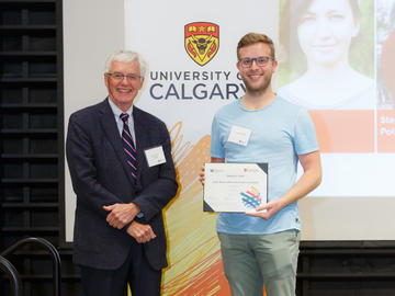 Stephen Pollo (Veterinary Medicine), right, receives a Second Year Izaak Walton Killam Memorial Scholarship from Killam Trustee Kevin Lynch, left