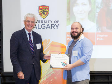 Luis Ponce Alvarez (Medicine, Biochemistry and Molecular Biology), right, receives a Second Year Izaak Walton Killam Memorial Scholarship from Killam Trustee Kevin Lynch, left