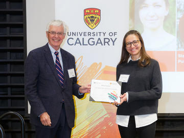 Maria Pavlova (Clinical Psychology), right, receives a Second Year Izaak Walton Killam Memorial Scholarship from Killam Trustee Kevin Lynch, left