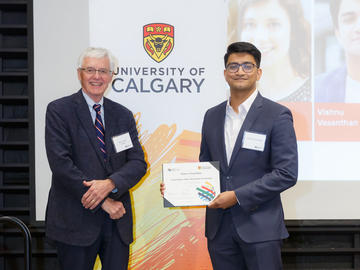 Vishnu Vasanthan (Medicine, Cardiovascular and Respiratory Sciences), right, receives a Second Year Izaak Walton Killam Memorial Scholarship from Killam Trustee Kevin Lynch, left