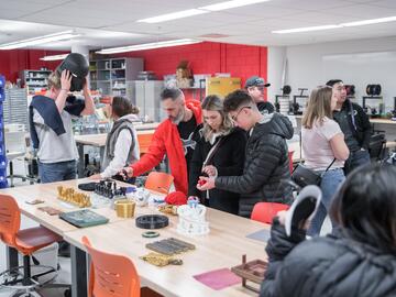 Open house attendees looking at 3D Printed items in Schulich