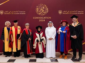 A group of of people in traditional dress and convocation regalia