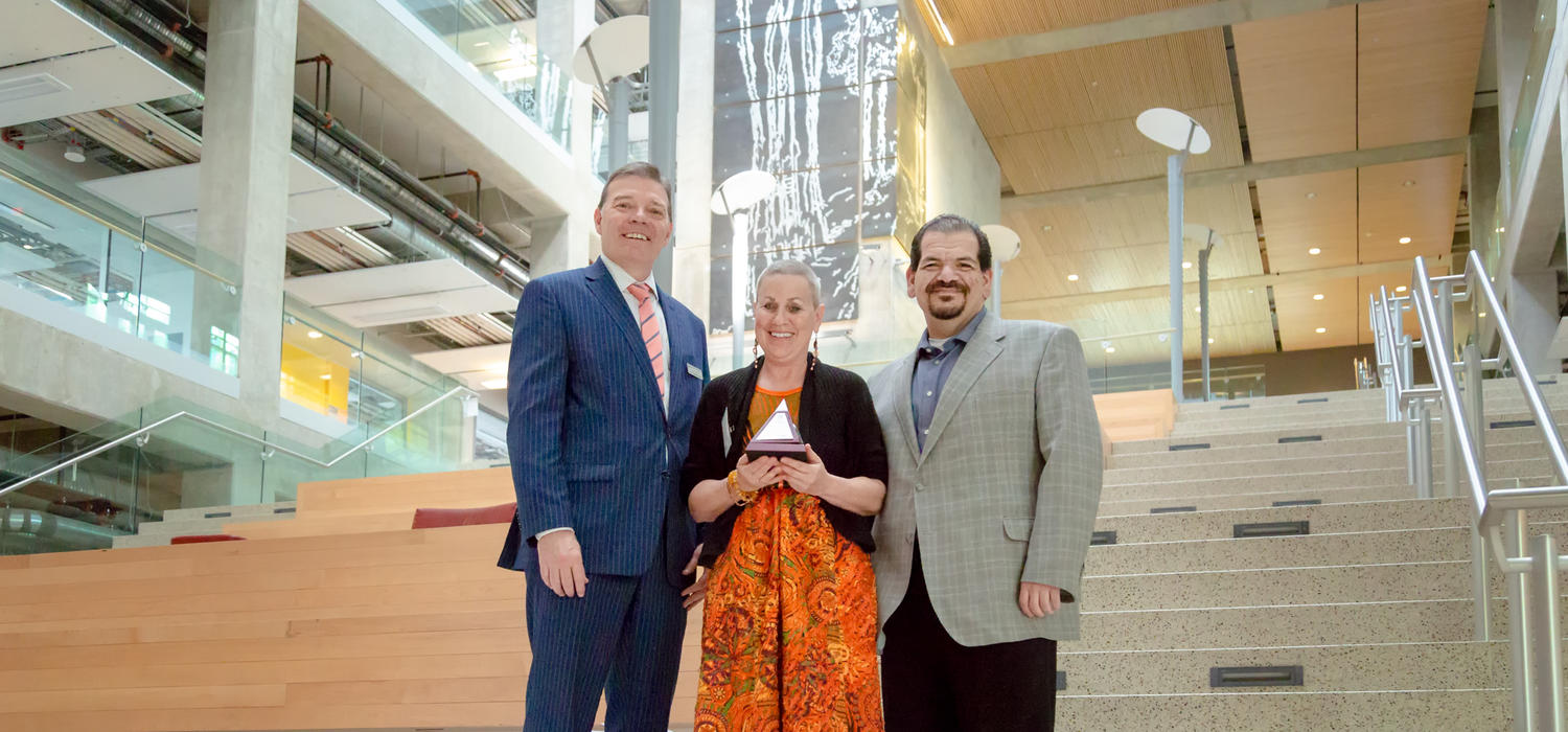 Valerie Pruegger, director of the Office of Diversity, Equity and Protected Disclosure, celebrates her Faculty of Arts Award with Dean Richard Sigurdson, left, and Michael Sclafani, associate vice-president, Alumni Engagement and Partnerships.