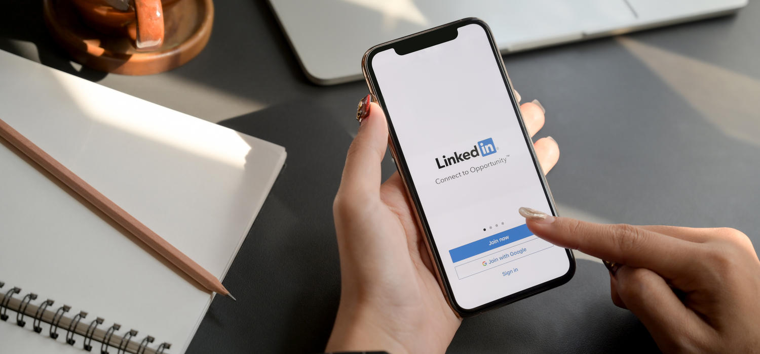 A user opening LinkedIn on their iPhone