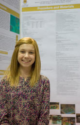 Colette Benko, a Grade 9 student from St. Gregory School, proudly shares her youth science fair project, Investigating Atypical Teratoid/Rhabdoid Tumor Exosomes. Photo by Riley Brandt, University of Calgary 