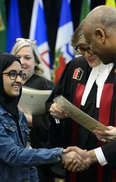 Youth receives Certificate of Citizenship from Immigration Minister