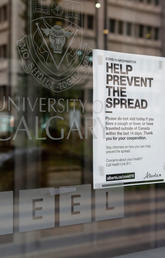 Sign on campus door says Help prevent the spread