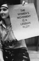 Women holding women's movement signs