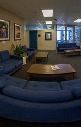 panorama of lounge space with blue couches and coffee tables