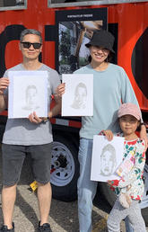 Attendees pose with IA generated portraits at the Lot 6 Activation hosted by the City of Calgary and SAPL’s Laboratory for Integrative Design