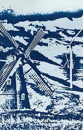 Cyanotype picture. A field of blue and white wind turbines with a windmill in the foreground.