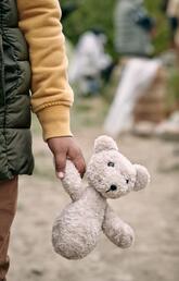A little girl holding a teddy bear