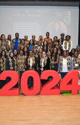 Students, faculty, and staff stand in front of ‘2024’ sign at the Black Brilliance Celebration