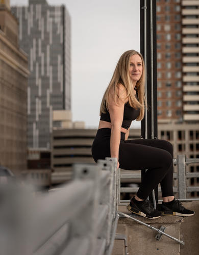 Jenn Varzari sits on a rooftop in downtown Calgary