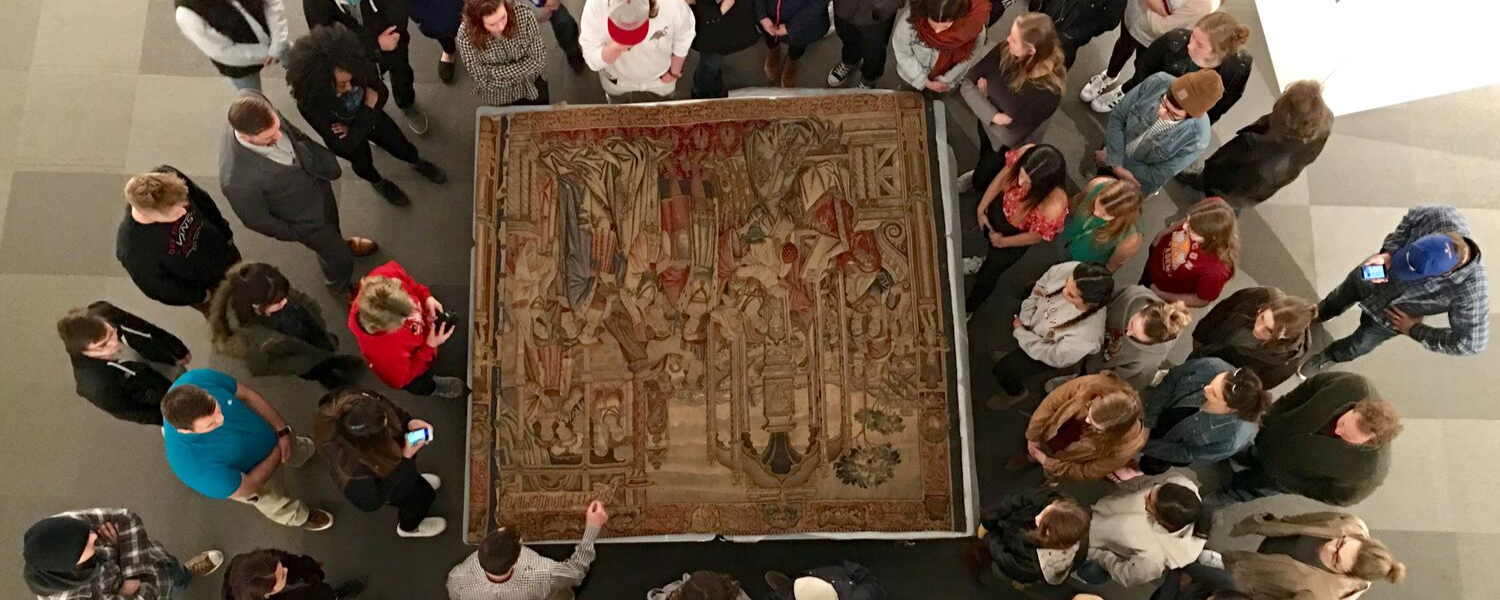 Students viewing a Belgian tapestry in the collection of Nickle Galleries, Photo John Hails