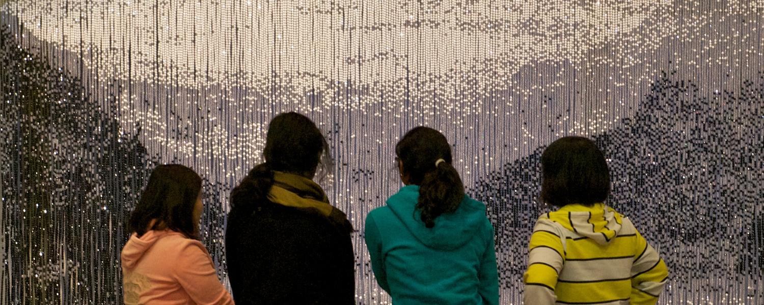 Students viewing Shelley Ouellet’s, Wish You Were Here... (Lake Louise), 2001, Courtesy Nickle Galleries. Photo: Dave Brown, LCR PhotoServices. 