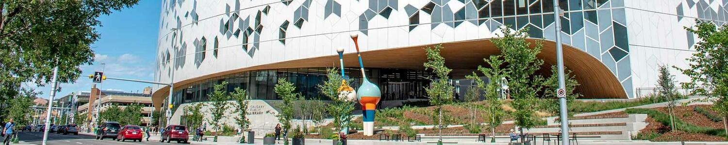 Photo of the Calgary Public Library, A modern building featuring a striking design of alternating white and blue tiles, showcasing a unique architectural style