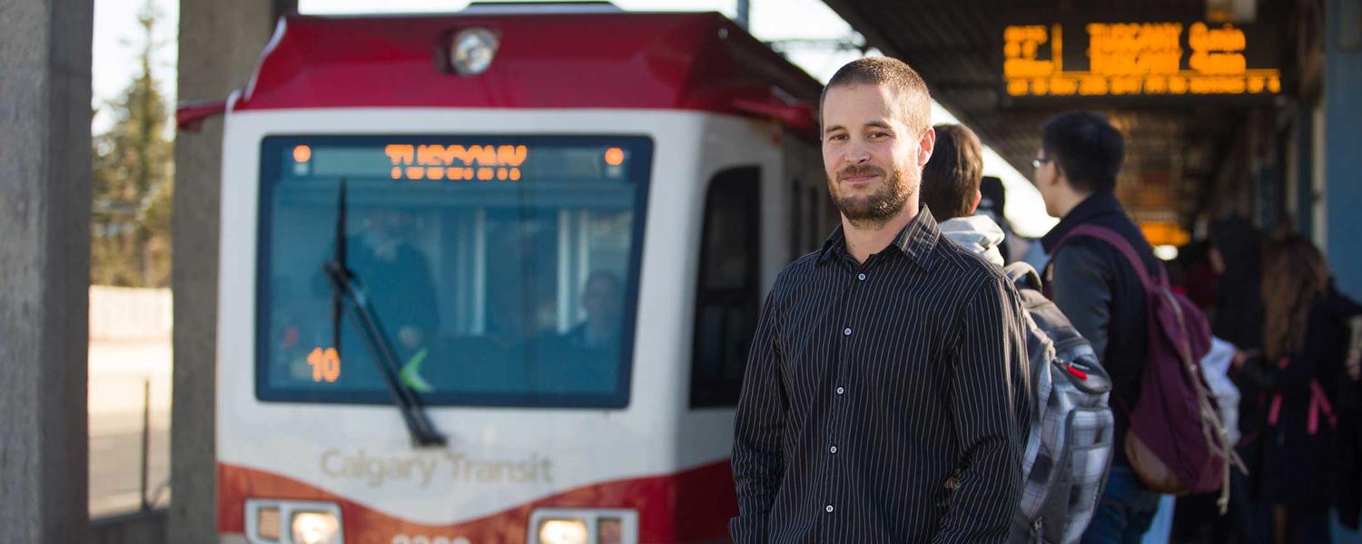 UCalgary Geography student Mark Pfeifer stands on the platform at University train station
