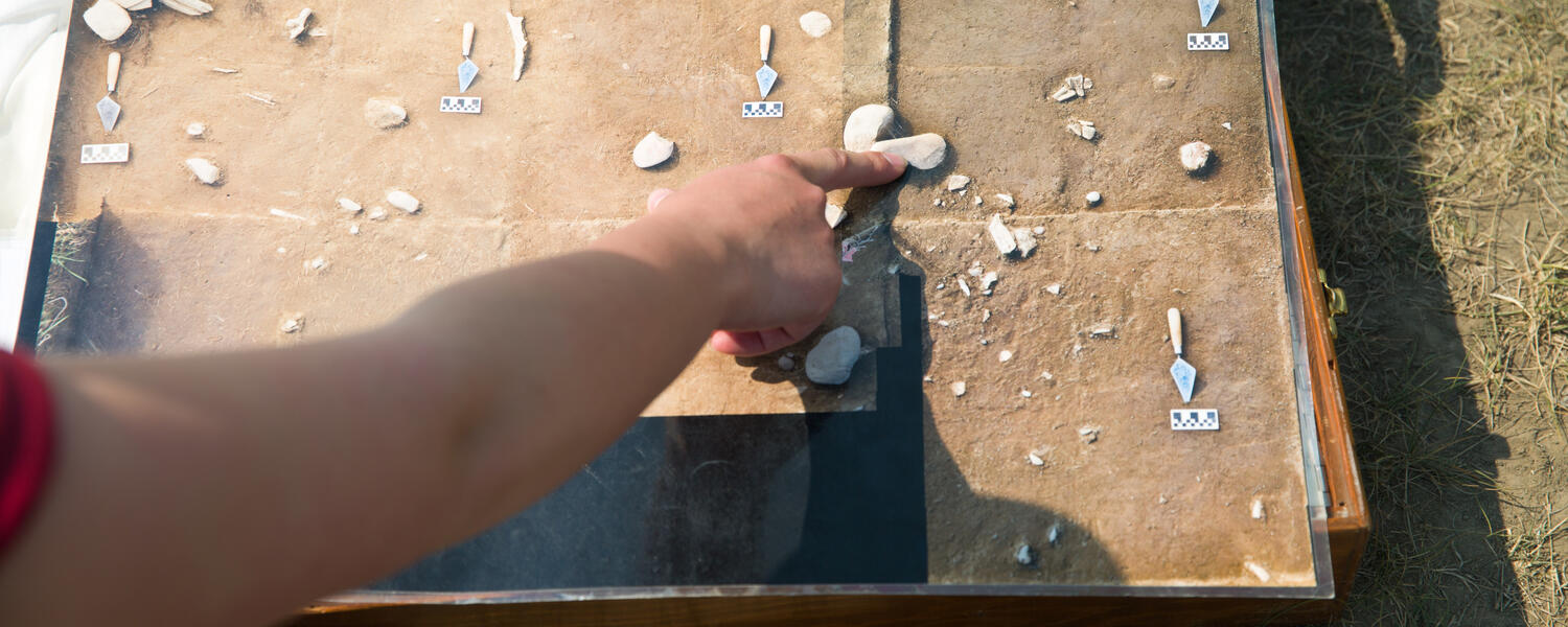 A person points at an image of artifacts from the Blackfoot Cluny site