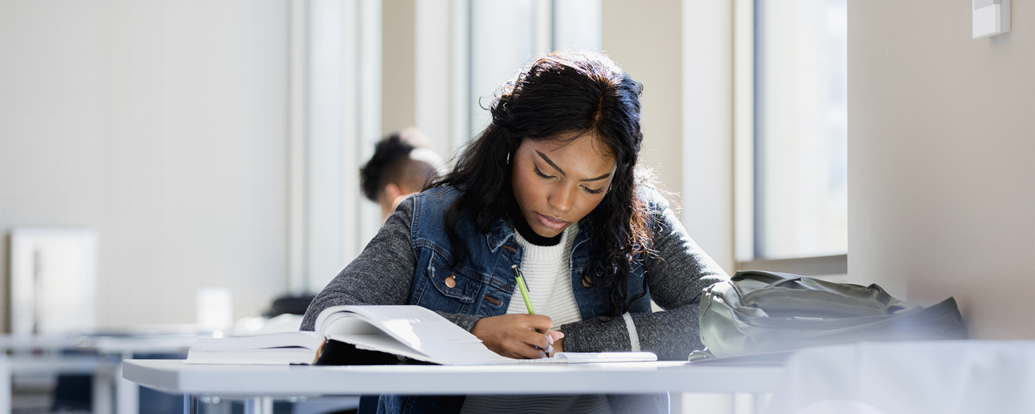 A woman studies over books