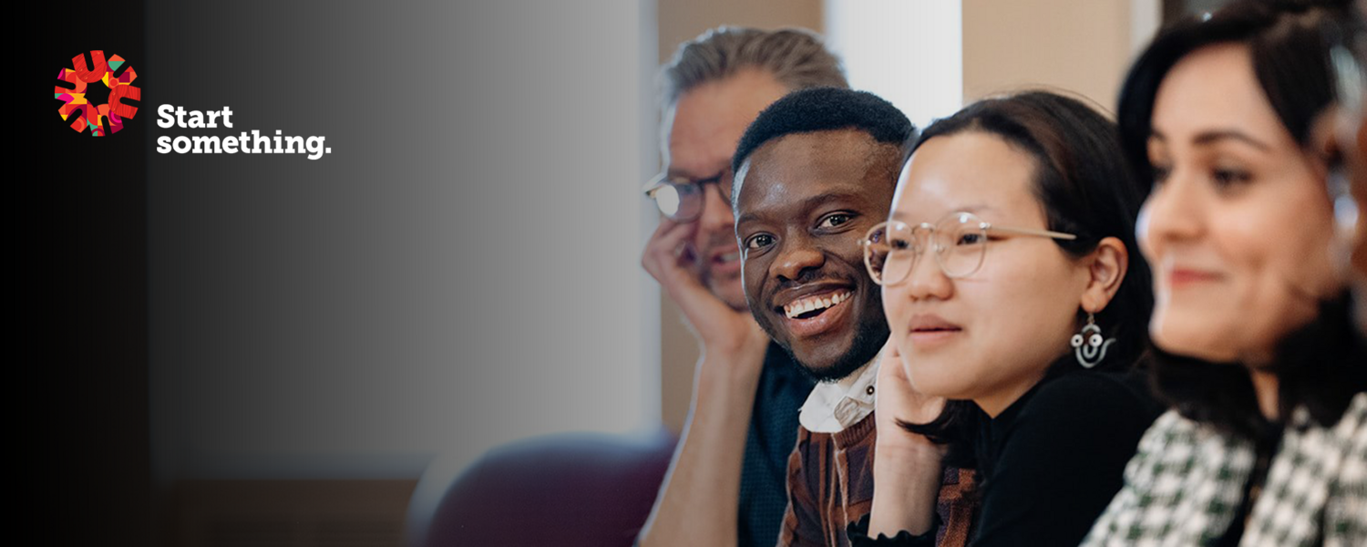 Four people are shown at a table, smiling at the camera. The UCalgary Arts spark and the words "Start something" appear on the graphic.