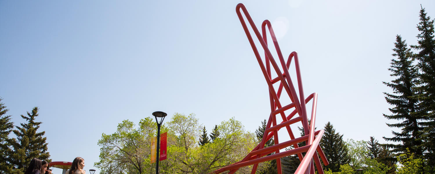 A red sculpture on the campus lawn