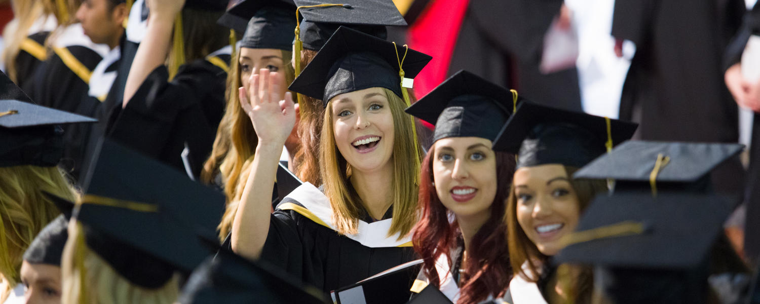 New grads smile in the convocation hall