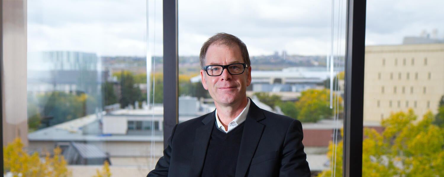 Director of the Calgary Institute for the Humanities, James Ellis, sits in a char in his office