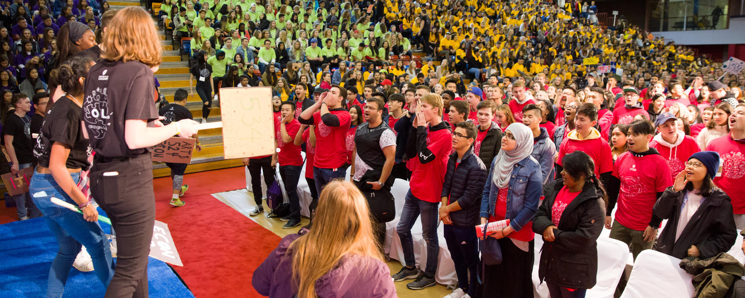Students gather in the red gym at induction day. They are all wearing branded indution day tshirts