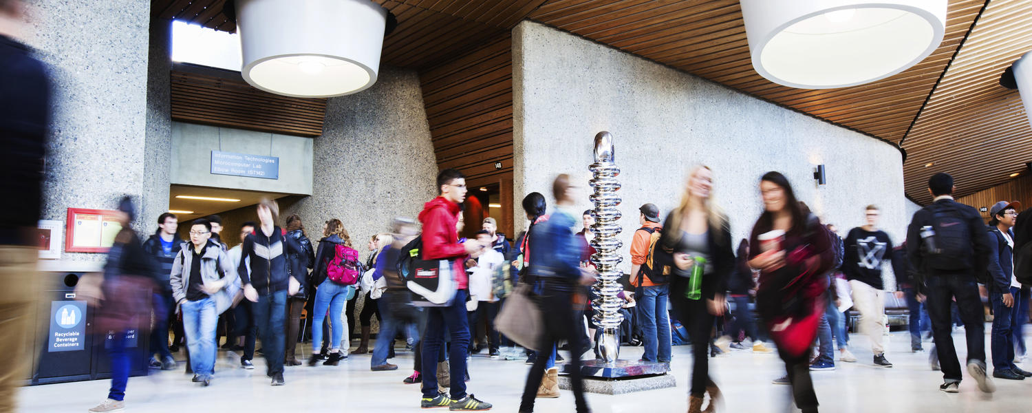 Science Theatres lobby in motion. Students are slightly blurred as they walk to and from class.